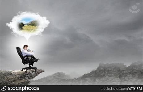 Young businessman sitting in chair and dreaming about something. A five minute break