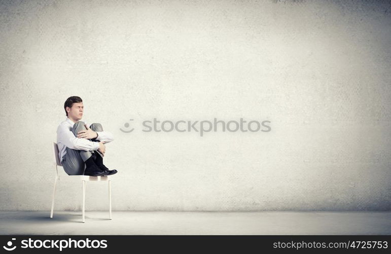 Young businessman sitting in chair and relaxing