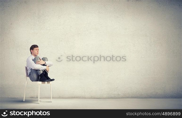 Young businessman sitting in chair and relaxing