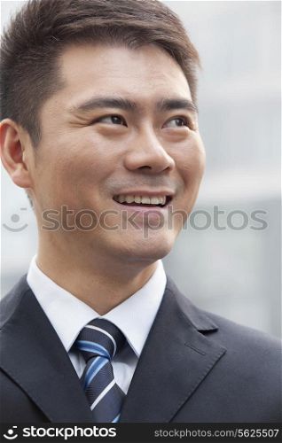 Young Businessman Smiling and Looking Away, Portrait
