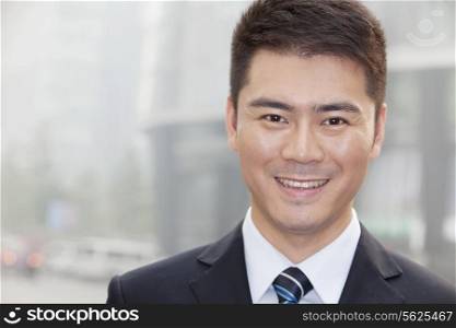 Young Businessman Smiling and Looking into Camera, Portrait