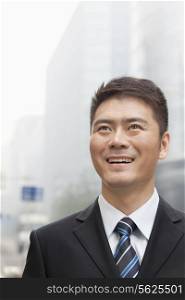Young Businessman Smiling and Looking into the Distance, Portrait