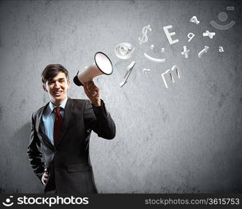 young businessman smiling in black suit holding megaphone