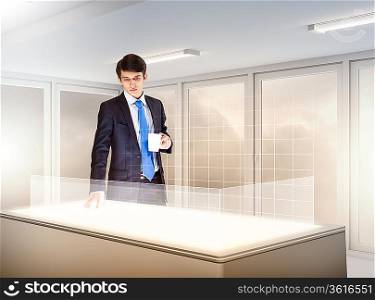 young businessman standing in background of high-tech image