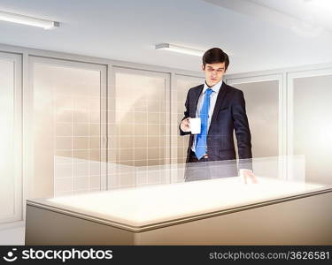 young businessman standing in background of high-tech image