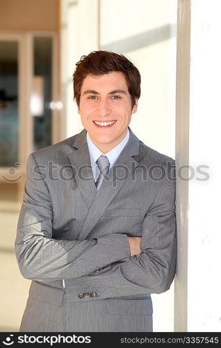 Young businessman standing in hall