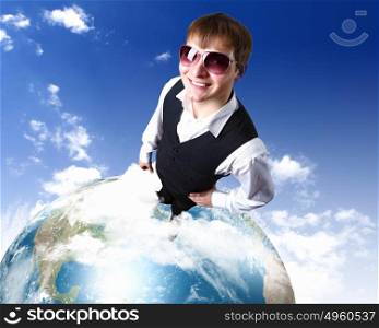 Young businessman standing on the planet earth model