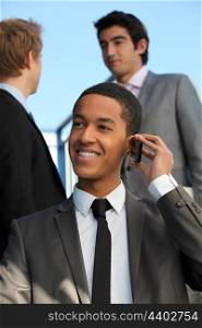 Young businessman talking on his mobile phone
