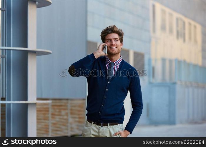 Young businessman talking smartphone phone walking on the street