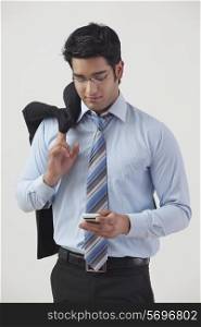 Young businessman text messaging