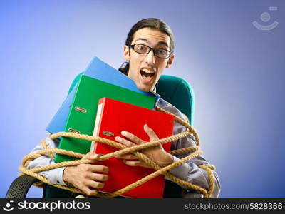 Young businessman tied with rope