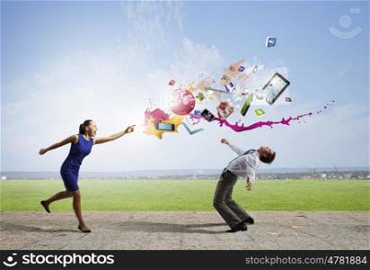 Young businessman trying to evade from thrown icons. Two business people fighting with each other