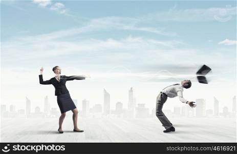 Young businessman trying to evade from thrown laptop. Two business people fighting with each other