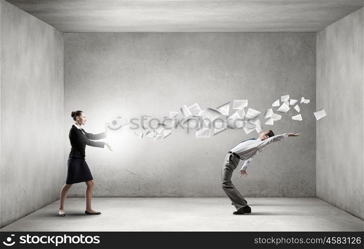 Young businessman trying to evade from thrown paper documents