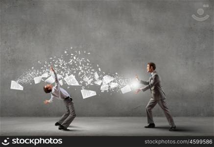 Young businessman trying to evade from thrown paper documents. Two business people fighting with each other