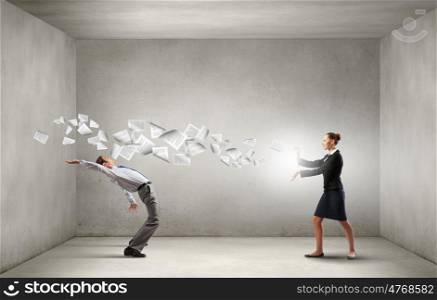 Young businessman trying to evade from thrown paper documents