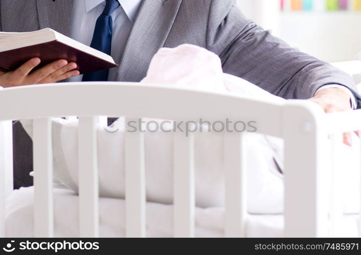 Young businessman trying to work from home caring after newborn baby. Young businessman trying to work from home caring after newborn