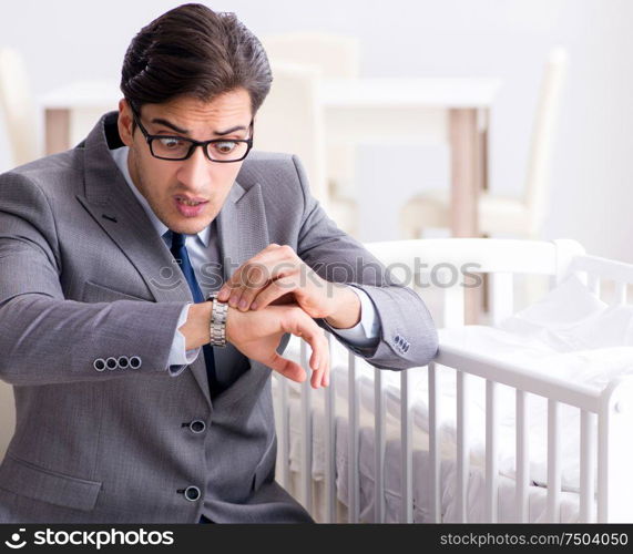 Young businessman trying to work from home caring after newborn baby. Young businessman trying to work from home caring after newborn