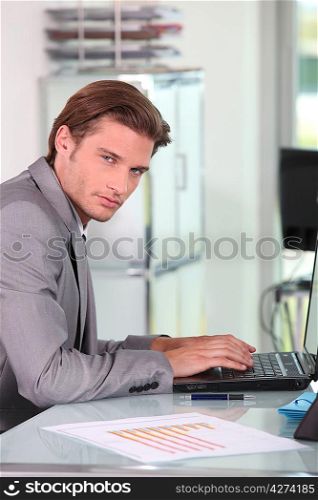 Young businessman typing
