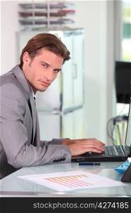 Young businessman typing