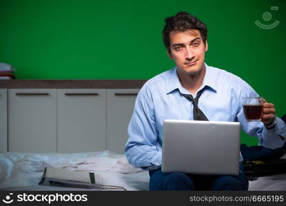 Young businessman under stress in the bedroom at night . Young businessman under stress in the bedroom at night