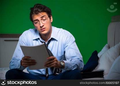 Young businessman under stress in the bedroom at night . Young businessman under stress in the bedroom at night
