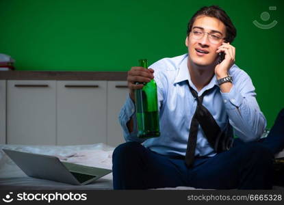 Young businessman under stress in the bedroom at night . Young businessman under stress in the bedroom at night