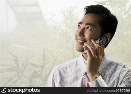 Young businessman using a cellular telephone