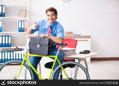 Young businessman using bike to commute to the office