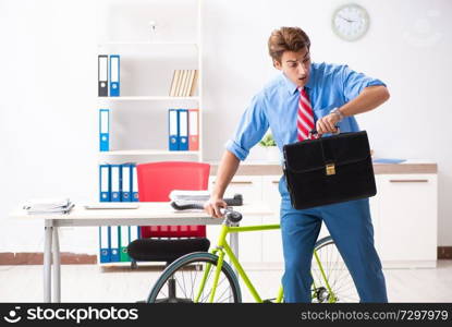 Young businessman using bike to commute to the office