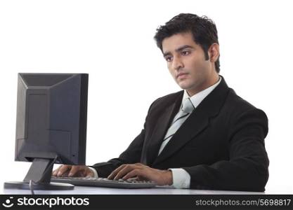 Young businessman using computer at desk