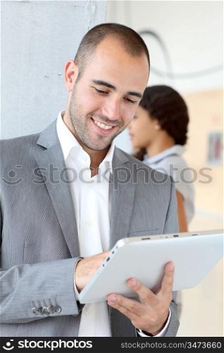 Young businessman using electronic tablet