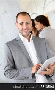 Young businessman using electronic tablet