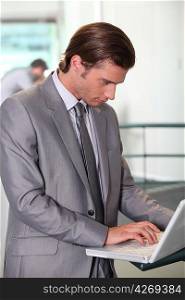 Young businessman using laptop computer