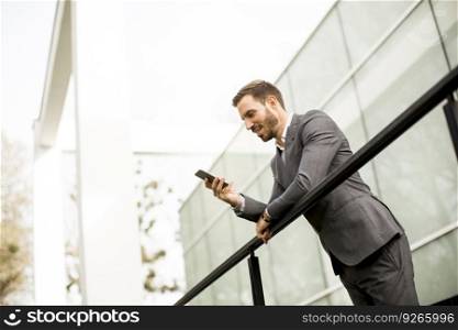 Young businessman using mobile phone at outdoor