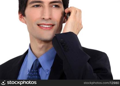 Young businessman using mobile telephone