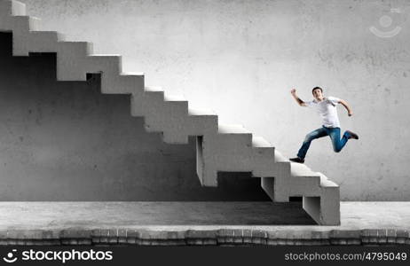 Young businessman walking up on staircase representing success concept. Up the career ladder