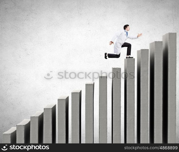 Young businessman walking up on staircase representing success concept. Up the career ladder