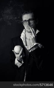 young businessman wearing glasses with cigarette and orange