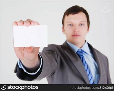 Young businessman with a blank business card
