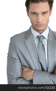 Young businessman with arms crossed