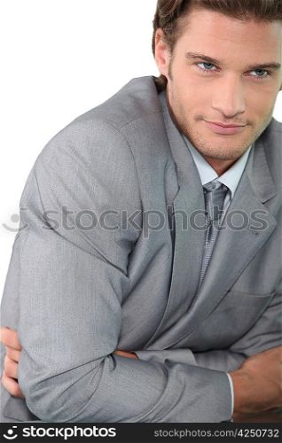Young businessman with arms folded