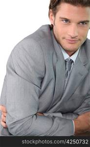Young businessman with arms folded