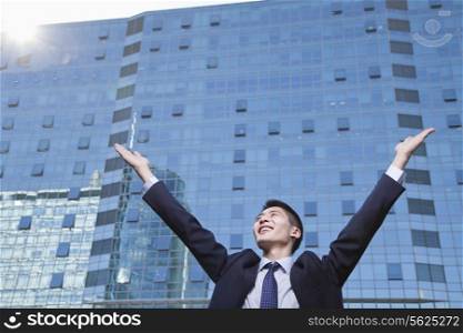 Young Businessman with arms raised