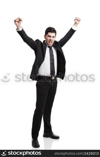 Young businessman with arms up isolated over a white background 