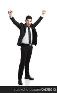 Young businessman with arms up isolated over a white background 