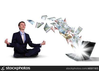 Young businessman with banknotes all around him