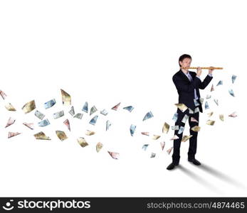 Young businessman with banknotes all around him