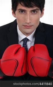 young businessman with boxing gloves