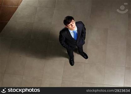 Young businessman with his eyes closed